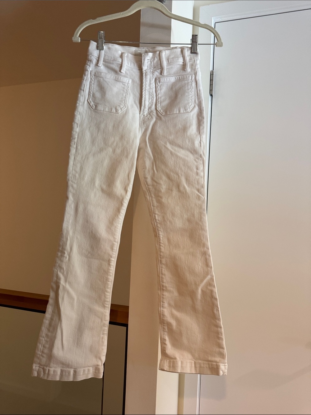 Mother Denim High-Rise Ivory/White Flare Jeans with patch pockets.
